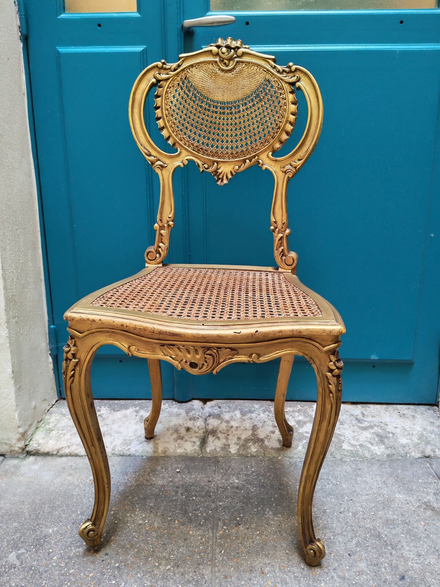 Antique rococo chair in gilded wood and caning