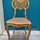 Antique rococo chair in gilded wood and caning