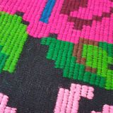Handwoven colorful Romanian carpet, green and black background with gorgeous colorful flowers