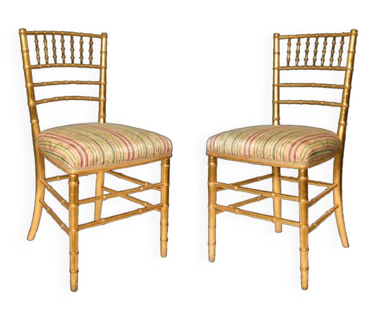 Pair of golden wood chairs in a bamboo style.