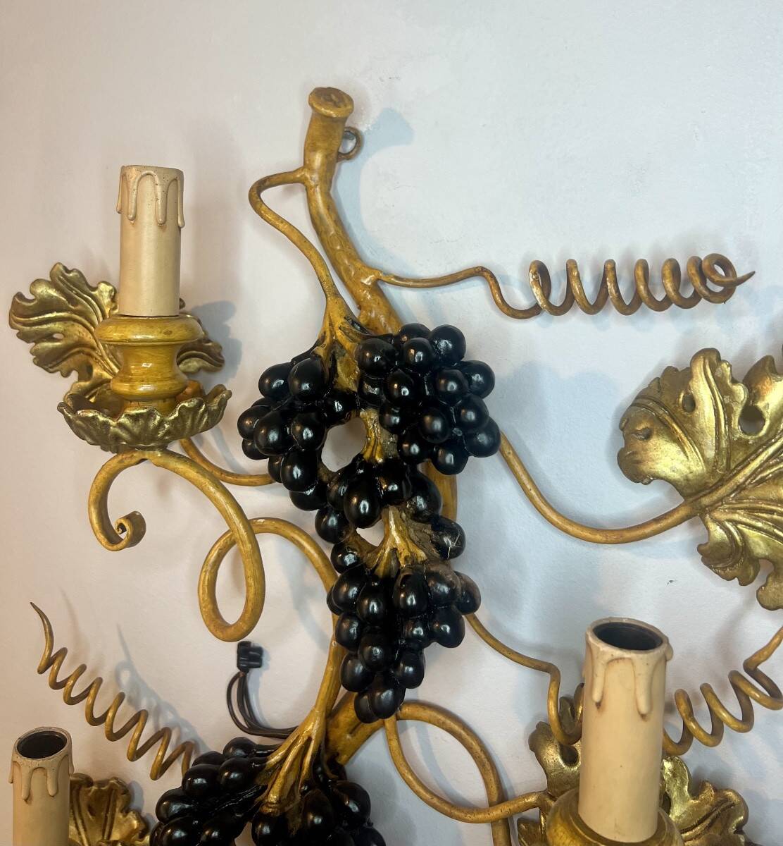 Large pair of wall sconces with vine decorations.