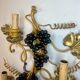 Large pair of wall sconces with vine decorations.