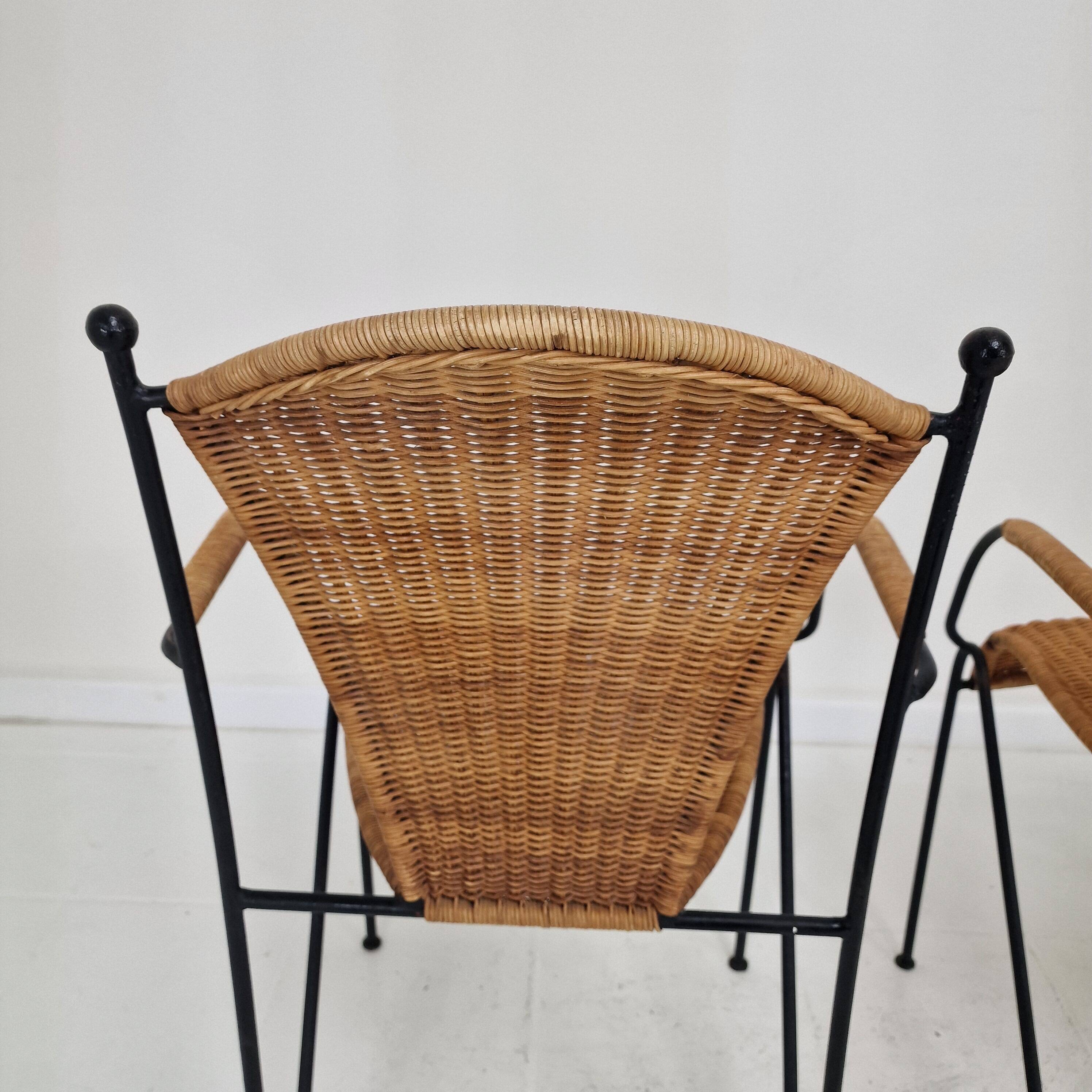 Pair of wicker and iron armchairs by Frederic Weinberg, United States, 1950s.