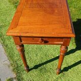 Antique solid wood table with a through drawer.