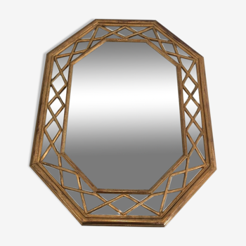 Octagonal mirror in gilded wood with closed guards