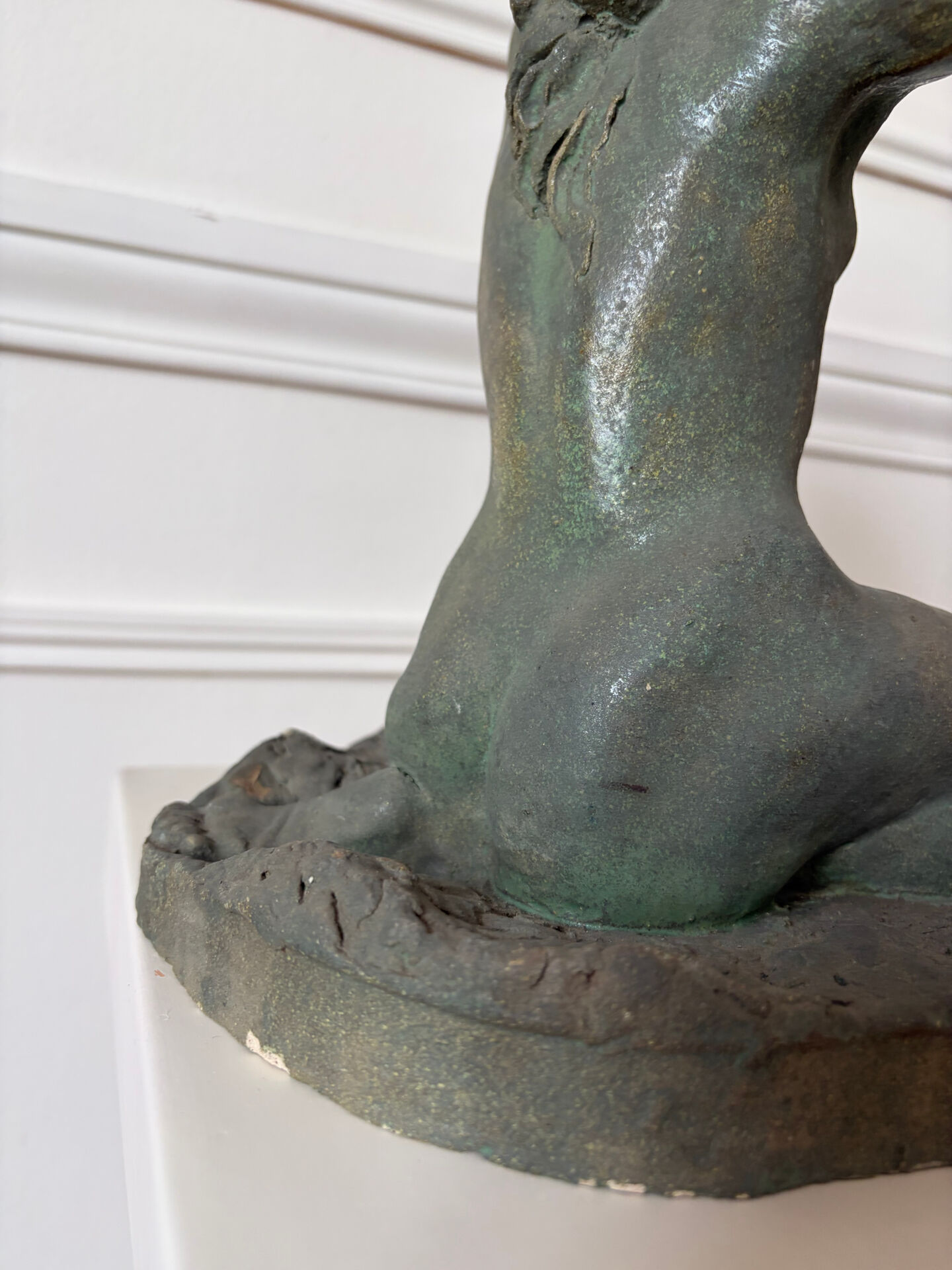 Sculpture of a naked woman titled "Youth" in terracotta.