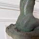 Sculpture of a naked woman titled "Youth" in terracotta.