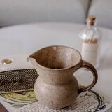 Small pitcher in old speckled stoneware