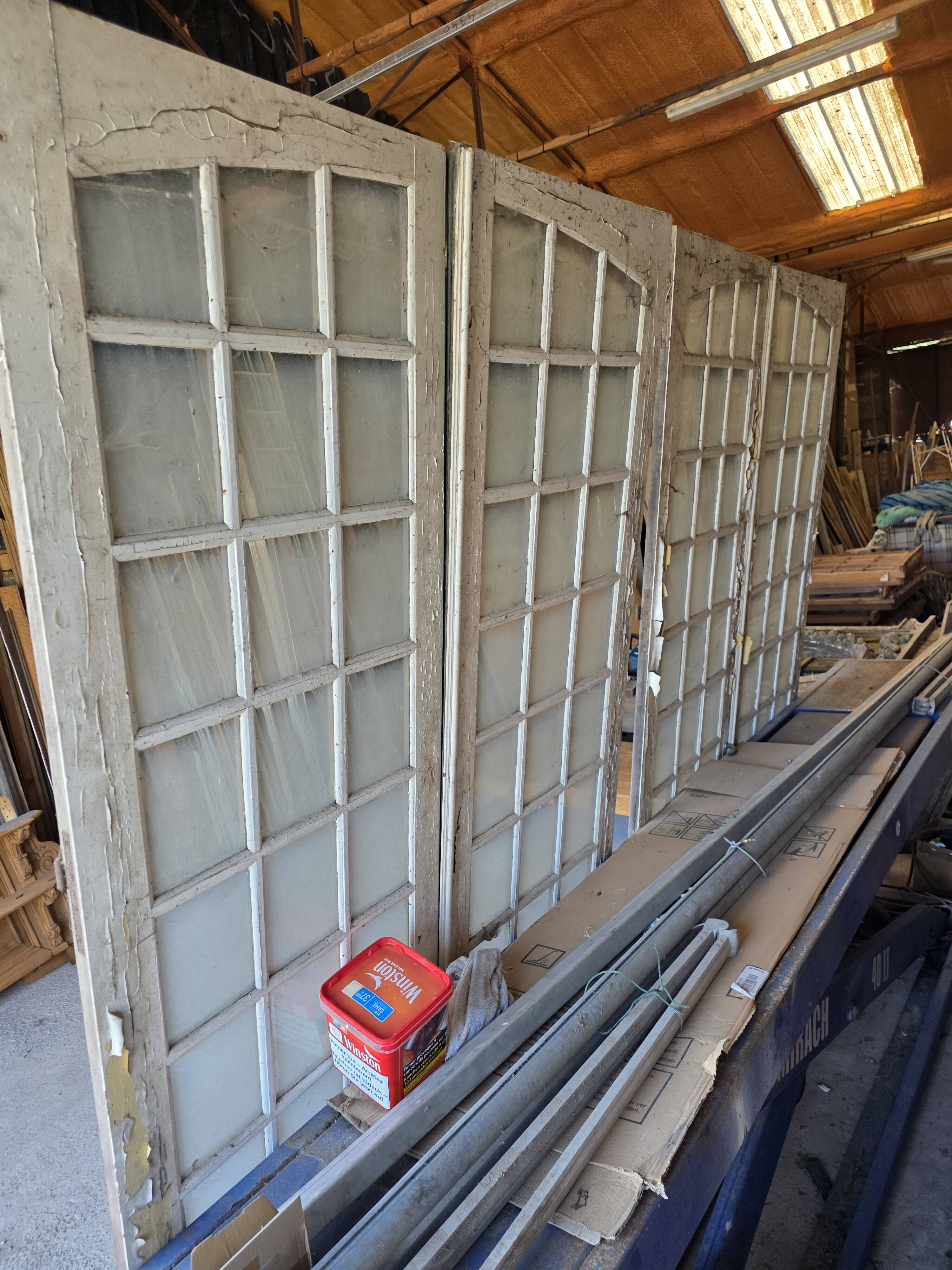 Two pairs of solid oak doors with small panes.