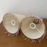 2 off-white fabric lampshades with pink and white tassels
