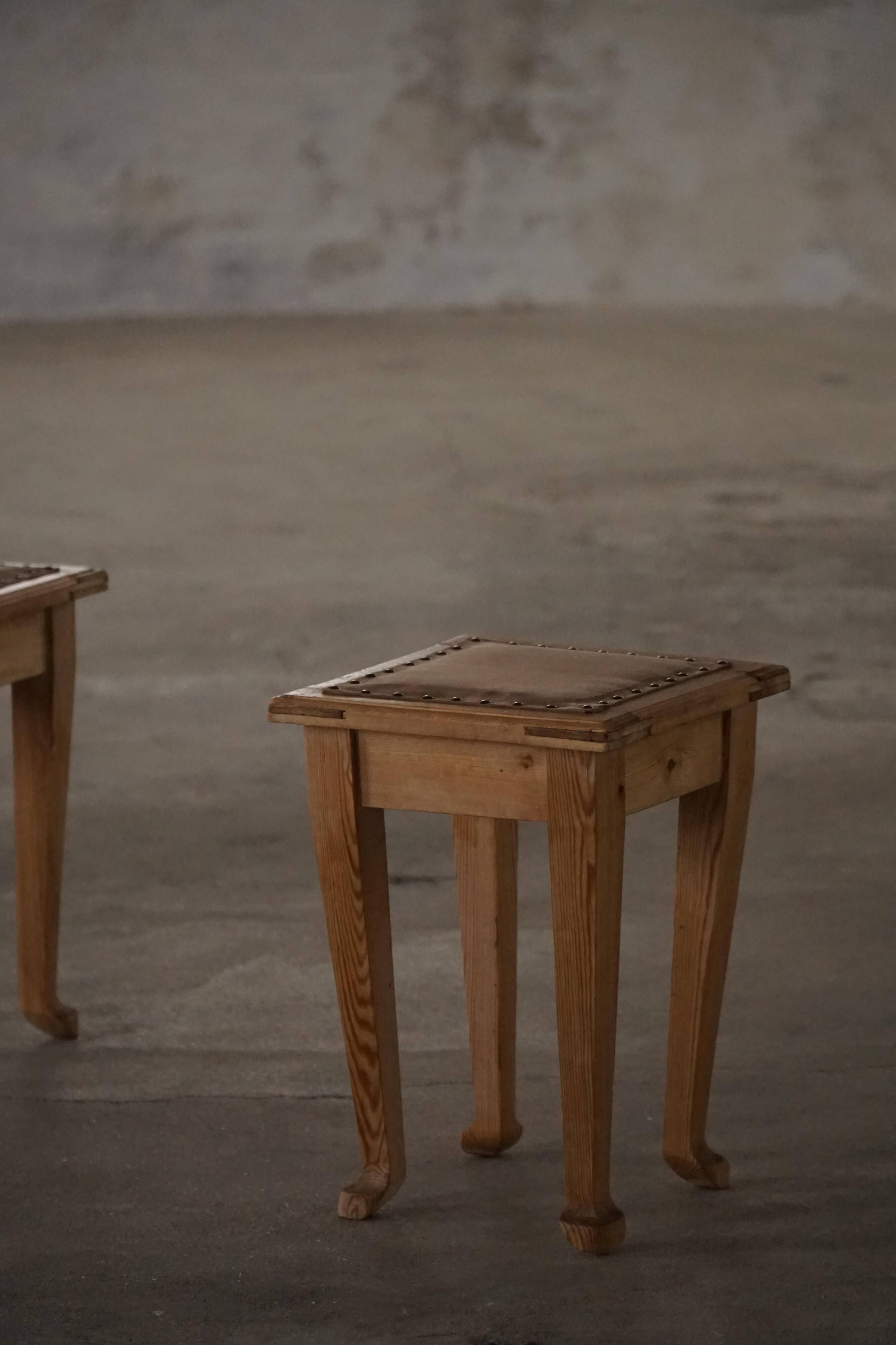 A pair of antique Danish pine stools from the late 19th century.