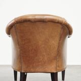 Very comfortable, elegant leather club armchair with a removable seat cushion and timeless design