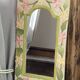 Carved wooden mirror, colourful floral decoration.