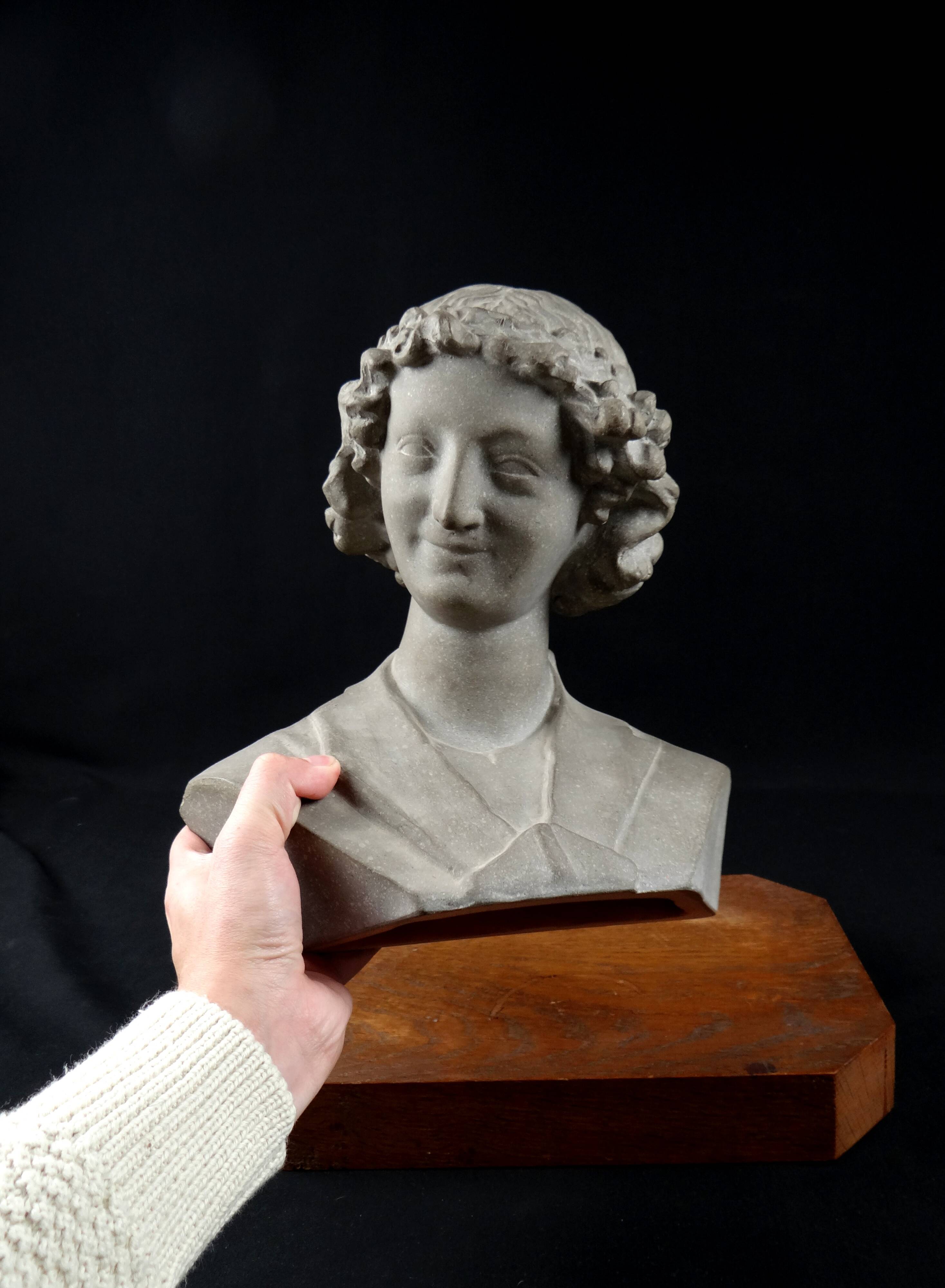 Terracotta bust of the smiling angel from Reims Cathedral with base
