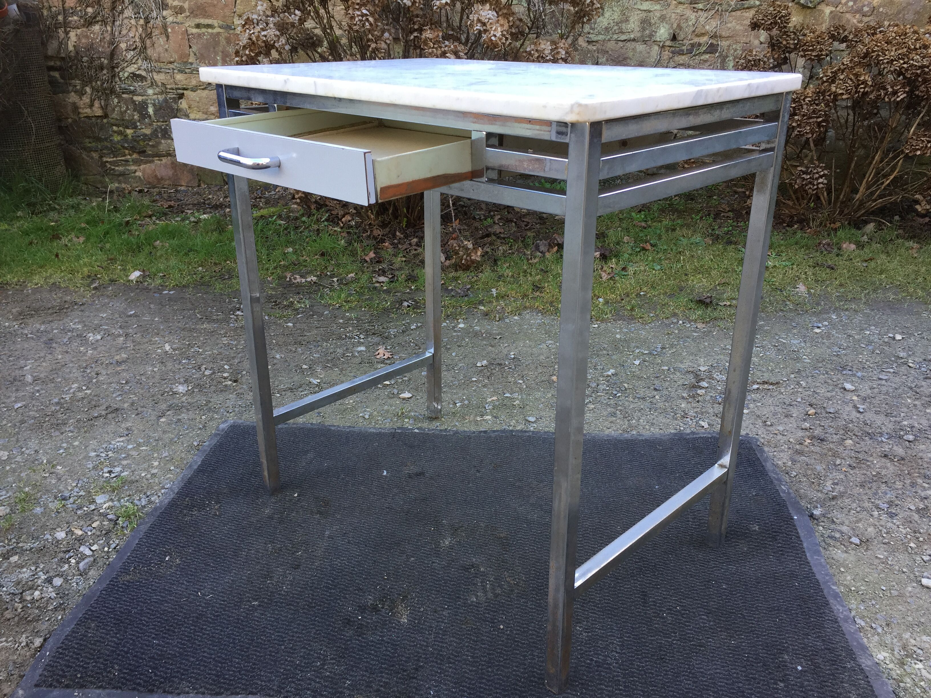 Vintage table with square chrome tubular metal base and marble top.