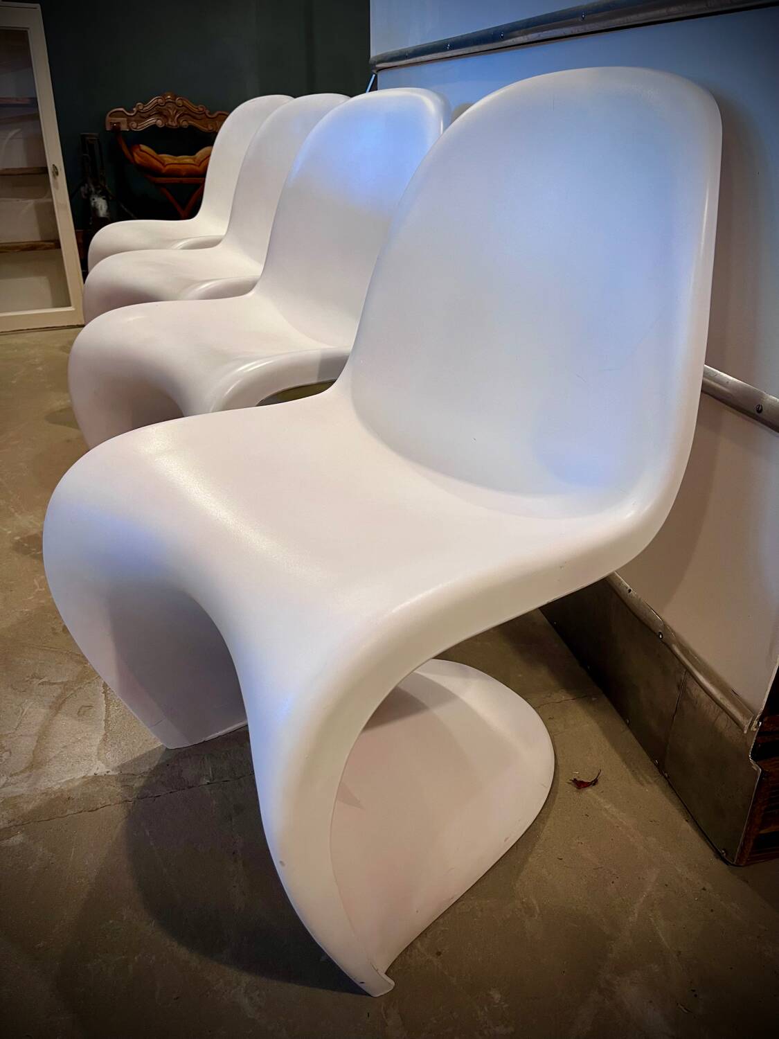 4 white Panton style armchairs