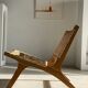 Reclining armchair in natural wood and woven rattan