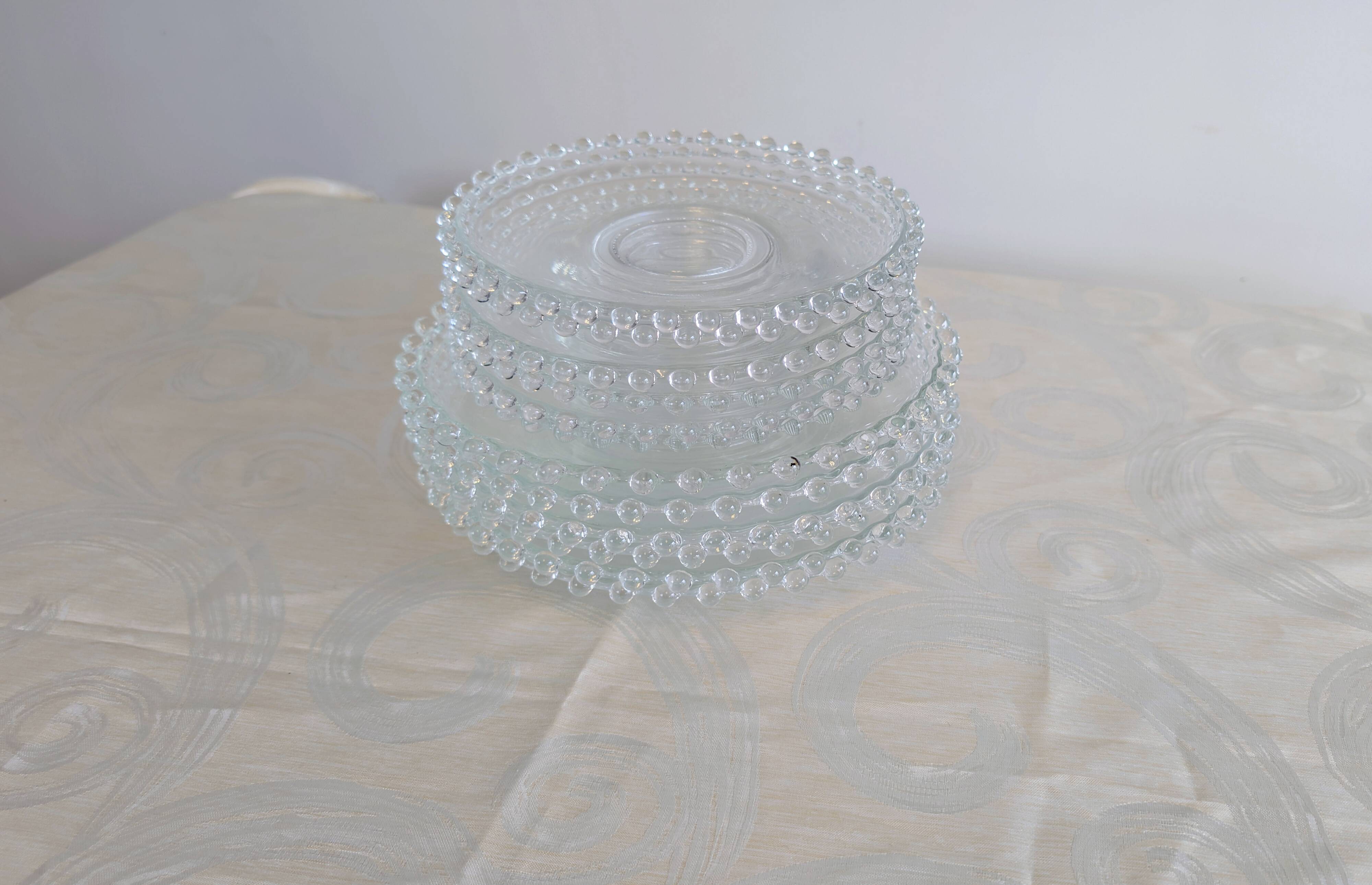 Vintage service of 12 pressed glass plates with bead decoration.
