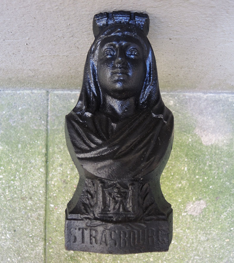 Old cast iron chenets : woman from strasbourg