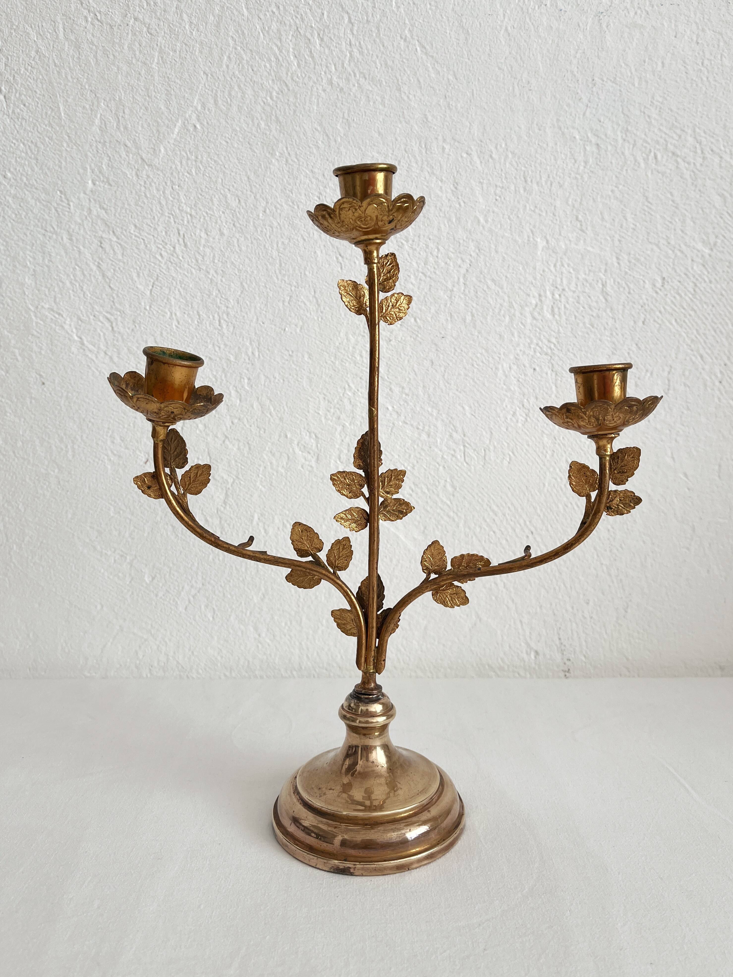 Antique bronze and brass candlestick with golden leaves