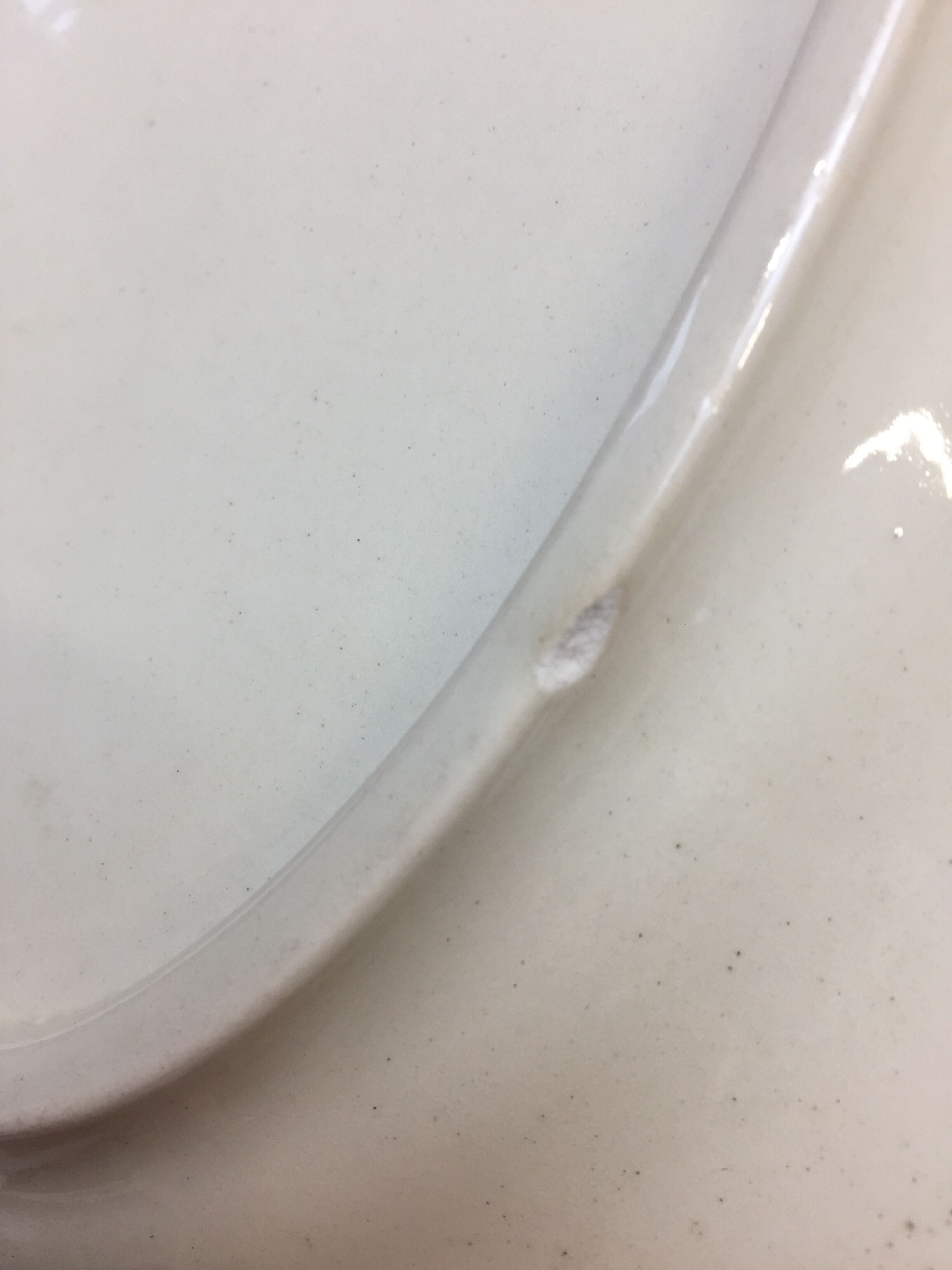 Old ivory-colored, oval-shaped dish with chamfered edge