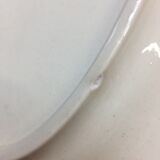 Old ivory-colored, oval-shaped dish with chamfered edge