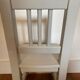 Small children's chair in antique white wood.