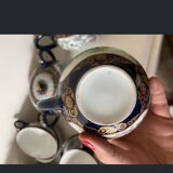 CHINA, 20th century Part of a porcelain tea service with polychrome decoration of palace scenes and v