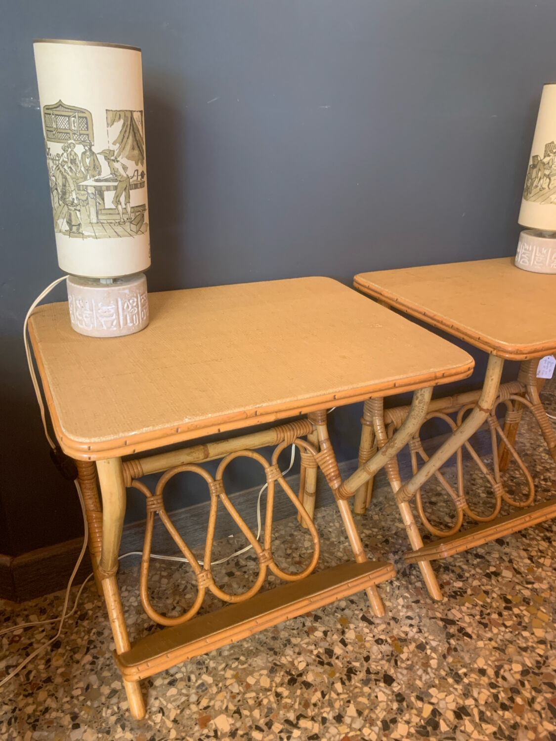 A pair of rattan bedside tables.
