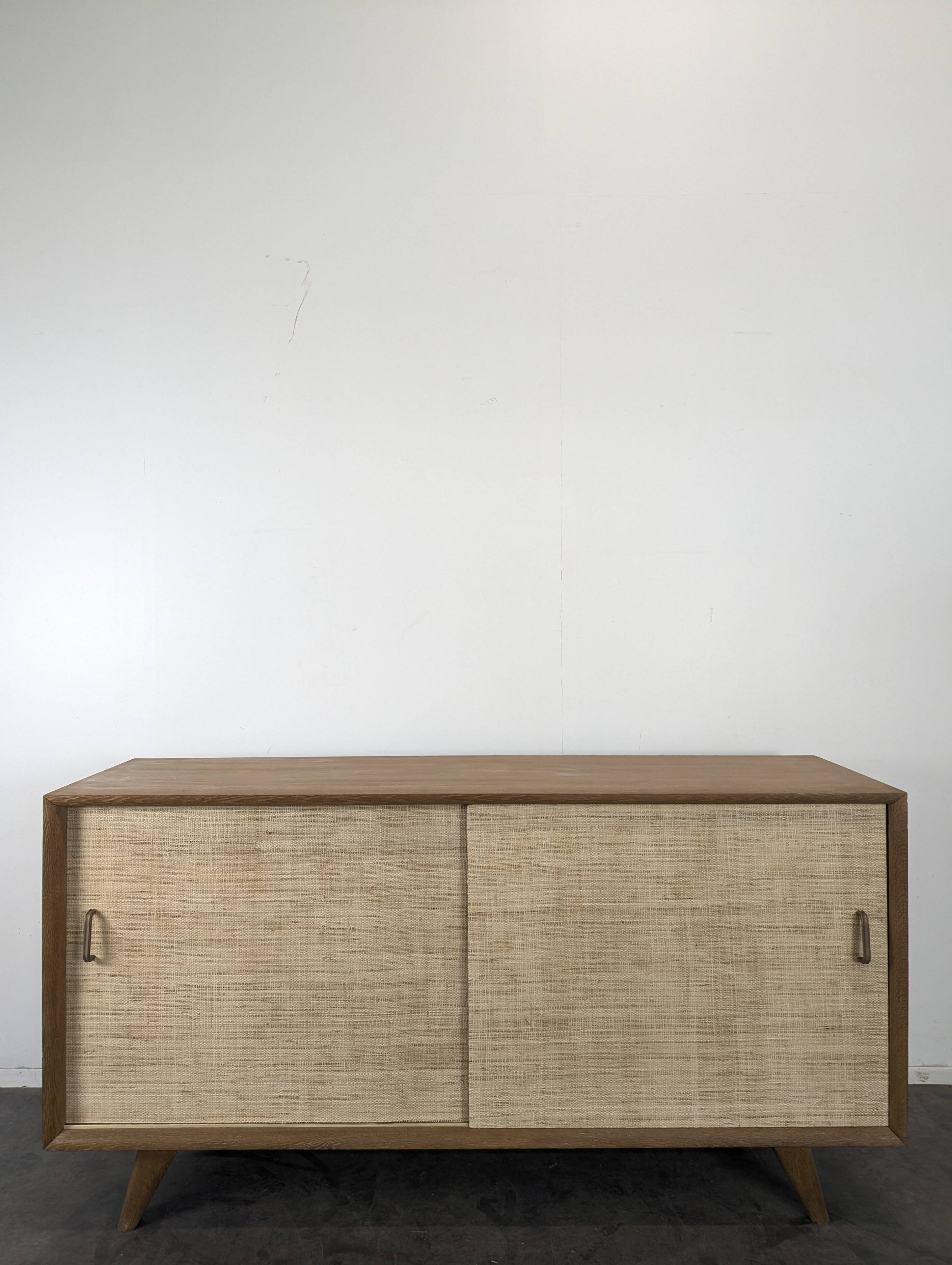 Modernist sideboard in oak with rattan doors.