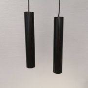 Two cylinder-shaped hanging lamps in black lacquer