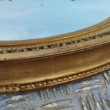 Antique oval mirror in gilded stucco with gold leaf, 19th century