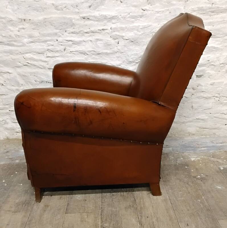 Antique club chair with mustache back