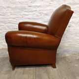 Antique club chair with mustache back