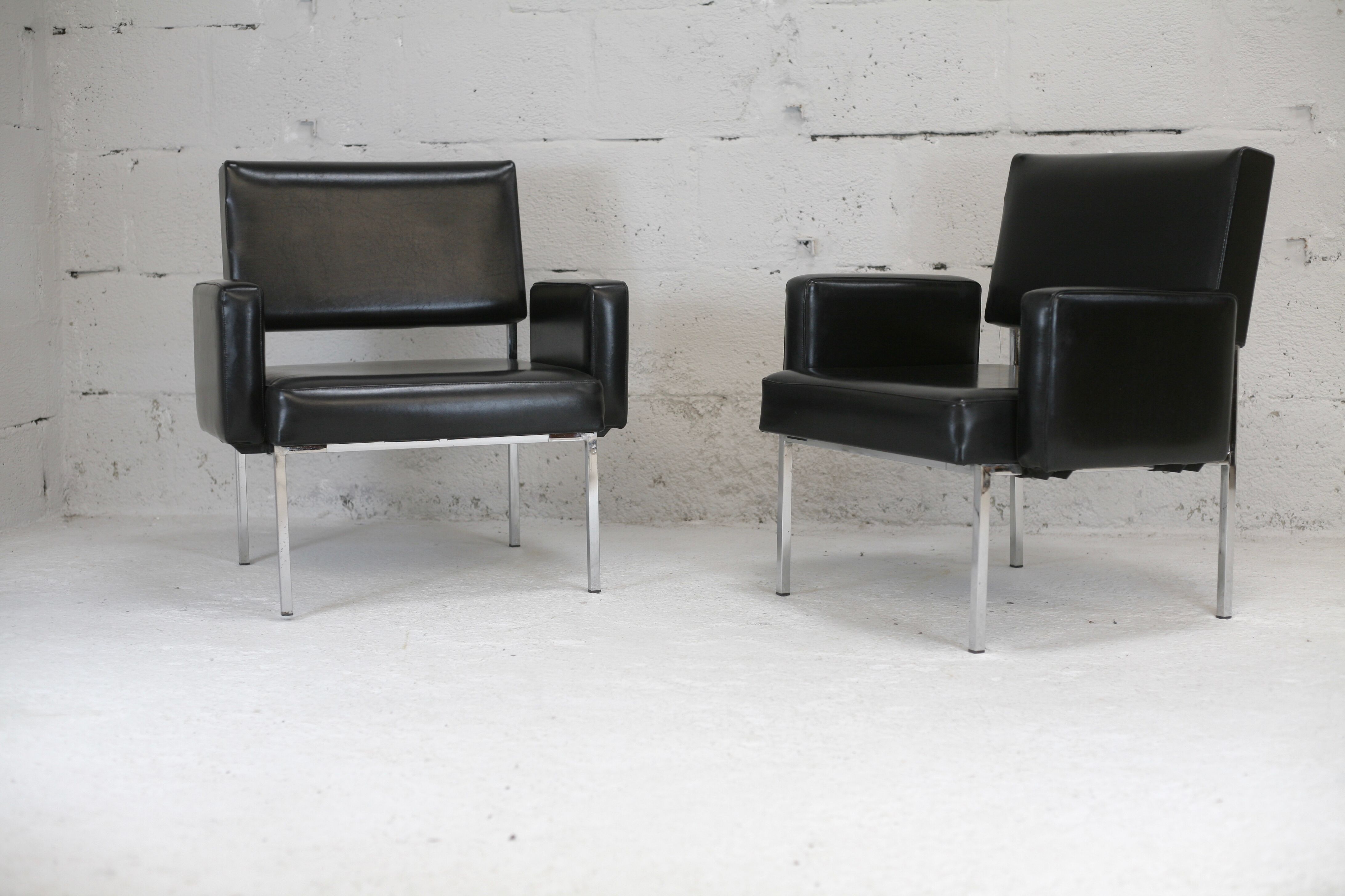 Pair of stainless steel, black leather-like armchairs, France, circa 1970
