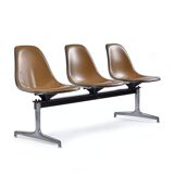 Tandem bench with brown Naugahyde pad shell chairs by Charles and Ray Eames for Herman Miller