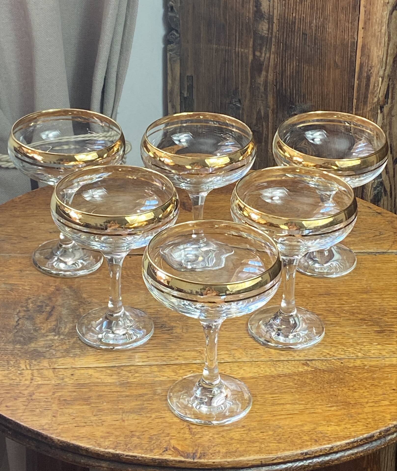 Champagne coupes or cocktail glasses with gilding