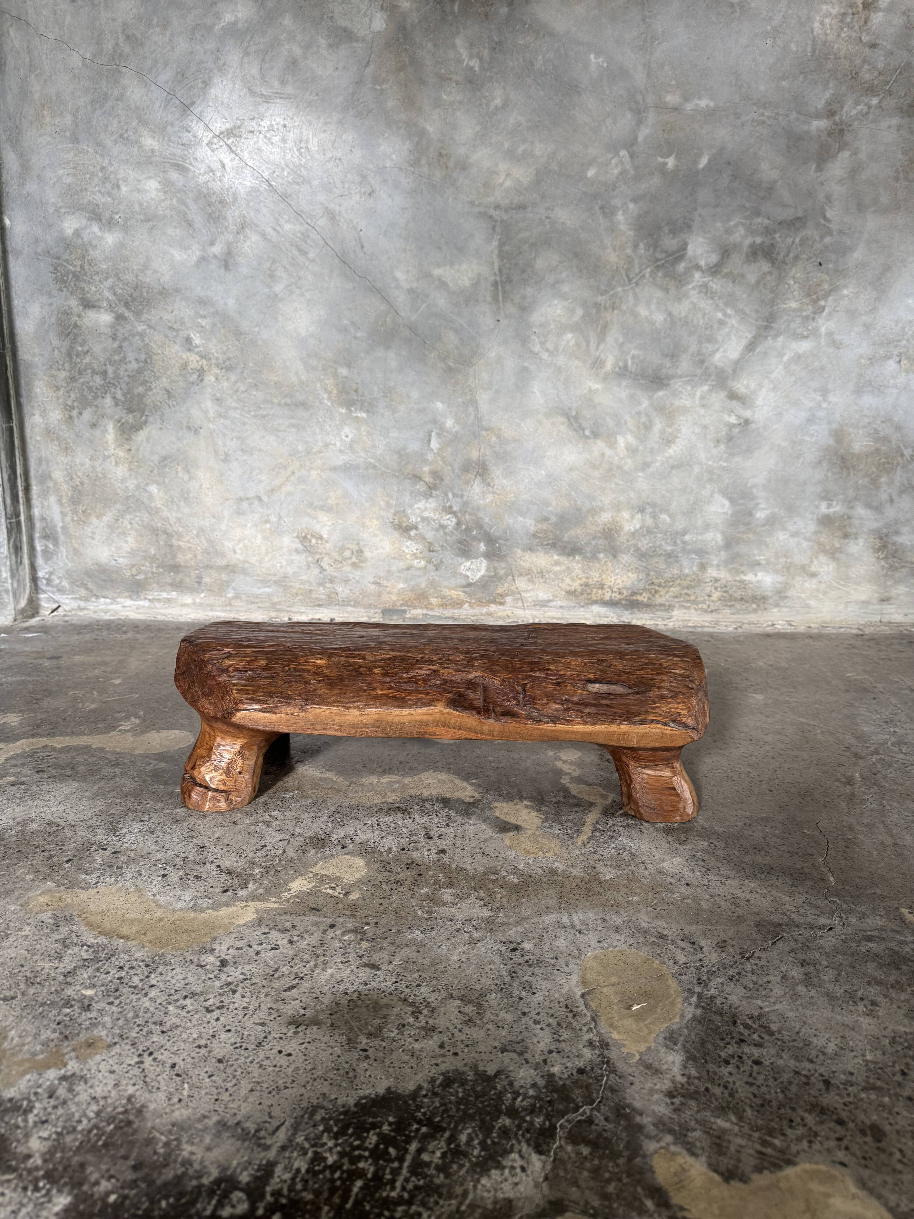 Small stool, footrest in blond teak, organic monoxyle with cut corners.