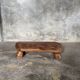 Small stool, footrest in blond teak, organic monoxyle with cut corners.