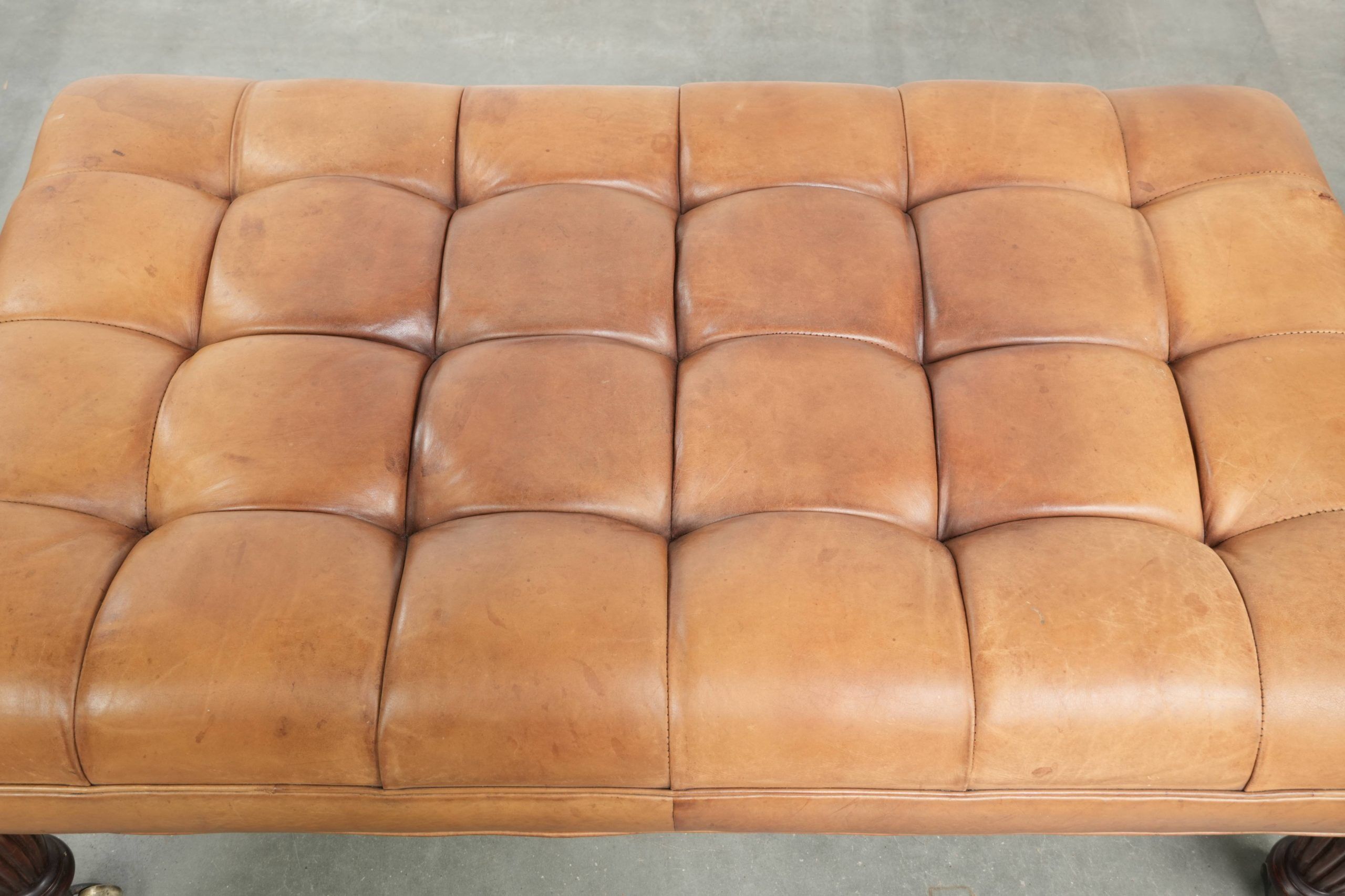 Sheepskin ottoman/coffee table on wheels in English chesterfield style