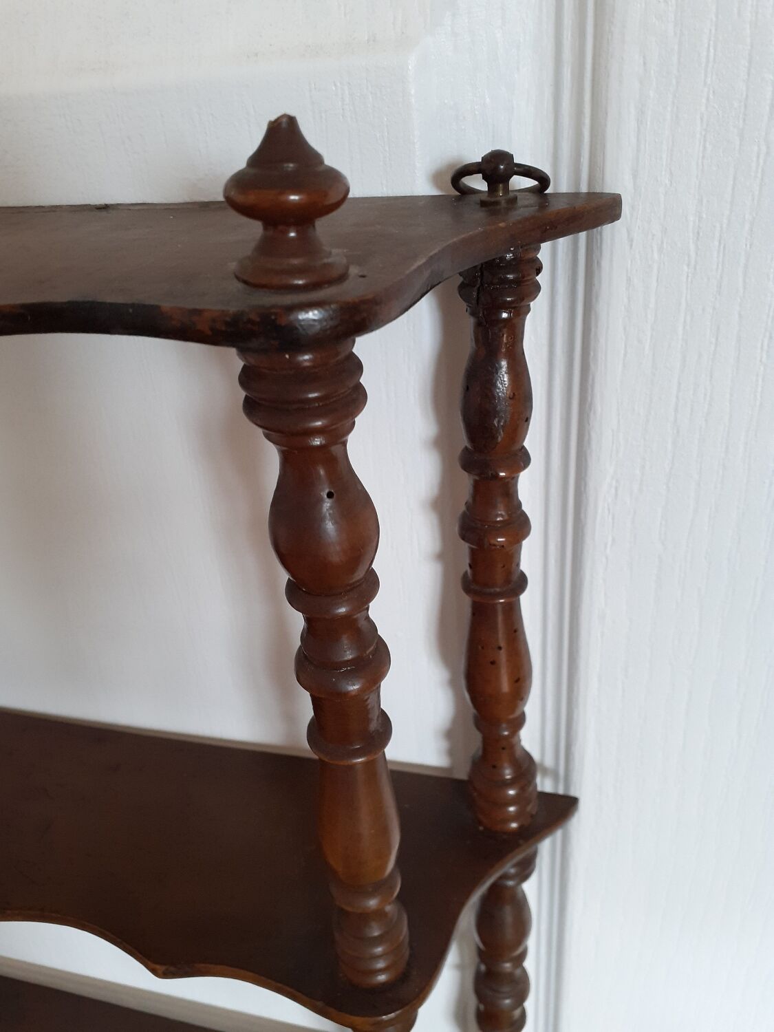 Turned wooden wall shelf