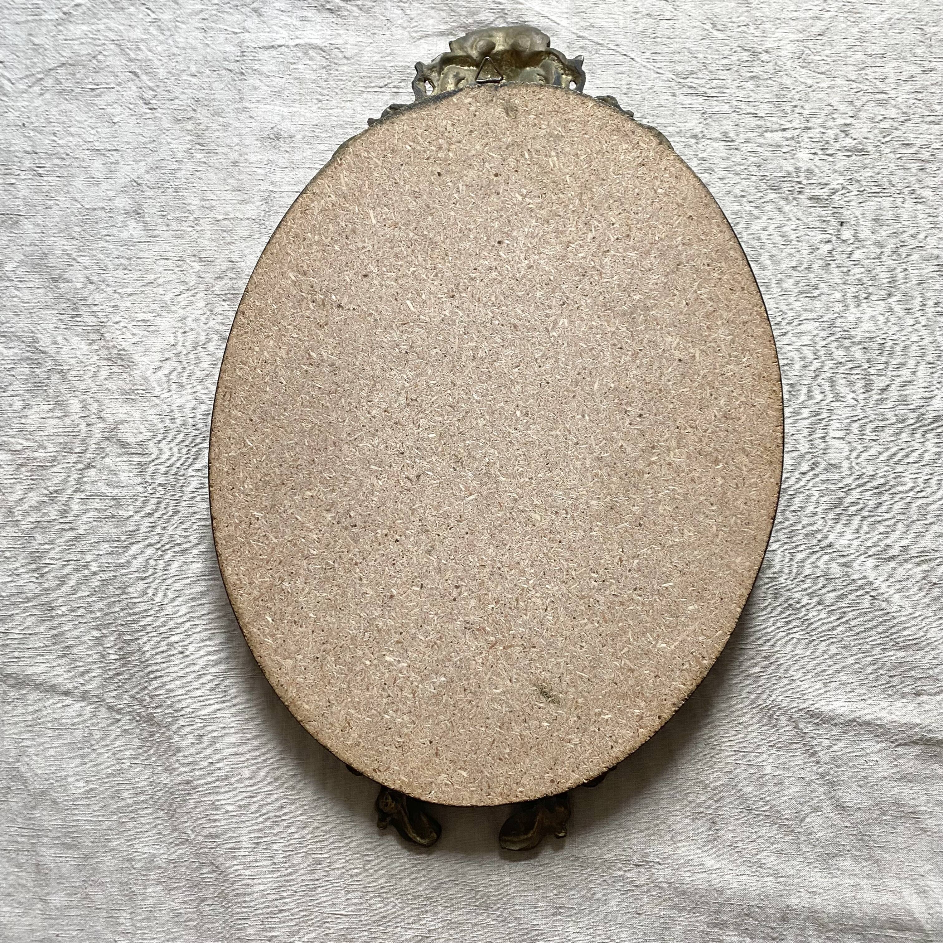 Antique oval brass crest mirror, 41x26 cm