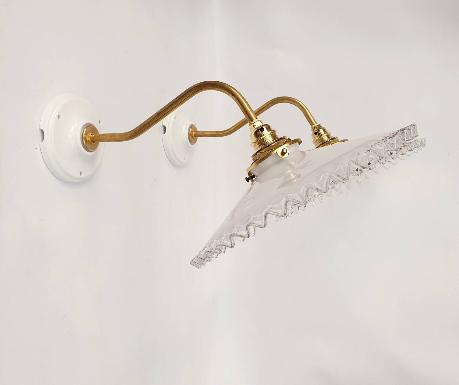 Swan neck sconces in serrated opaline