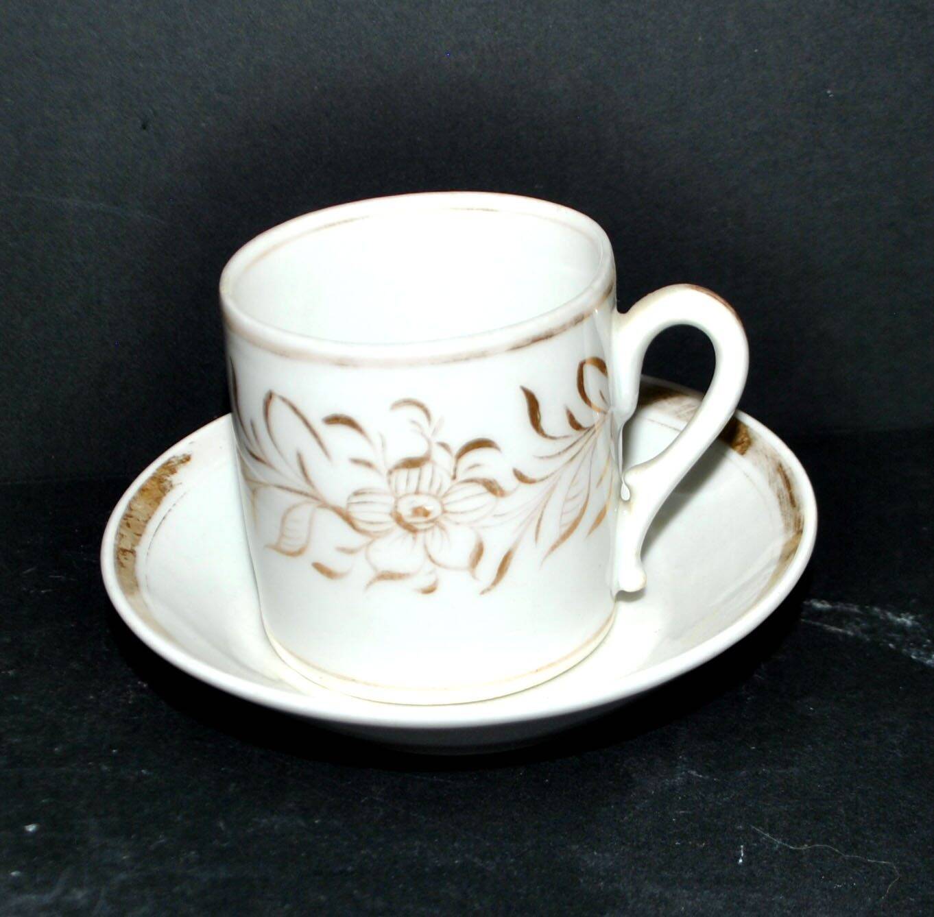 Paris porcelain coffee cup with floral design, antique porcelain with gold trim.