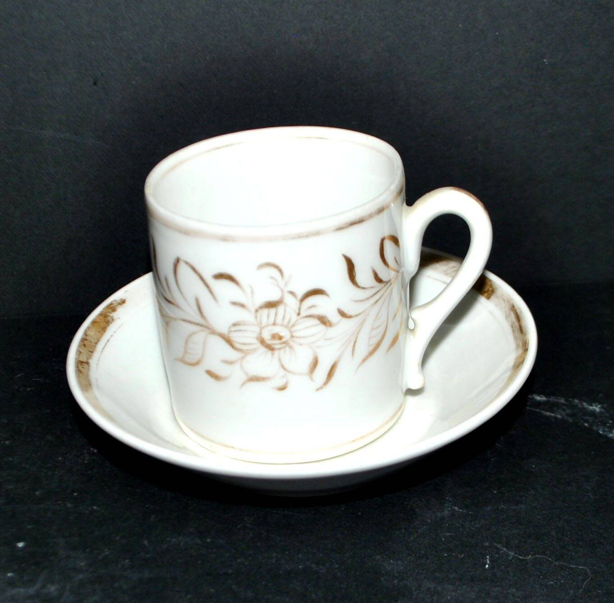 Paris porcelain coffee cup with floral design, antique porcelain with gold trim.