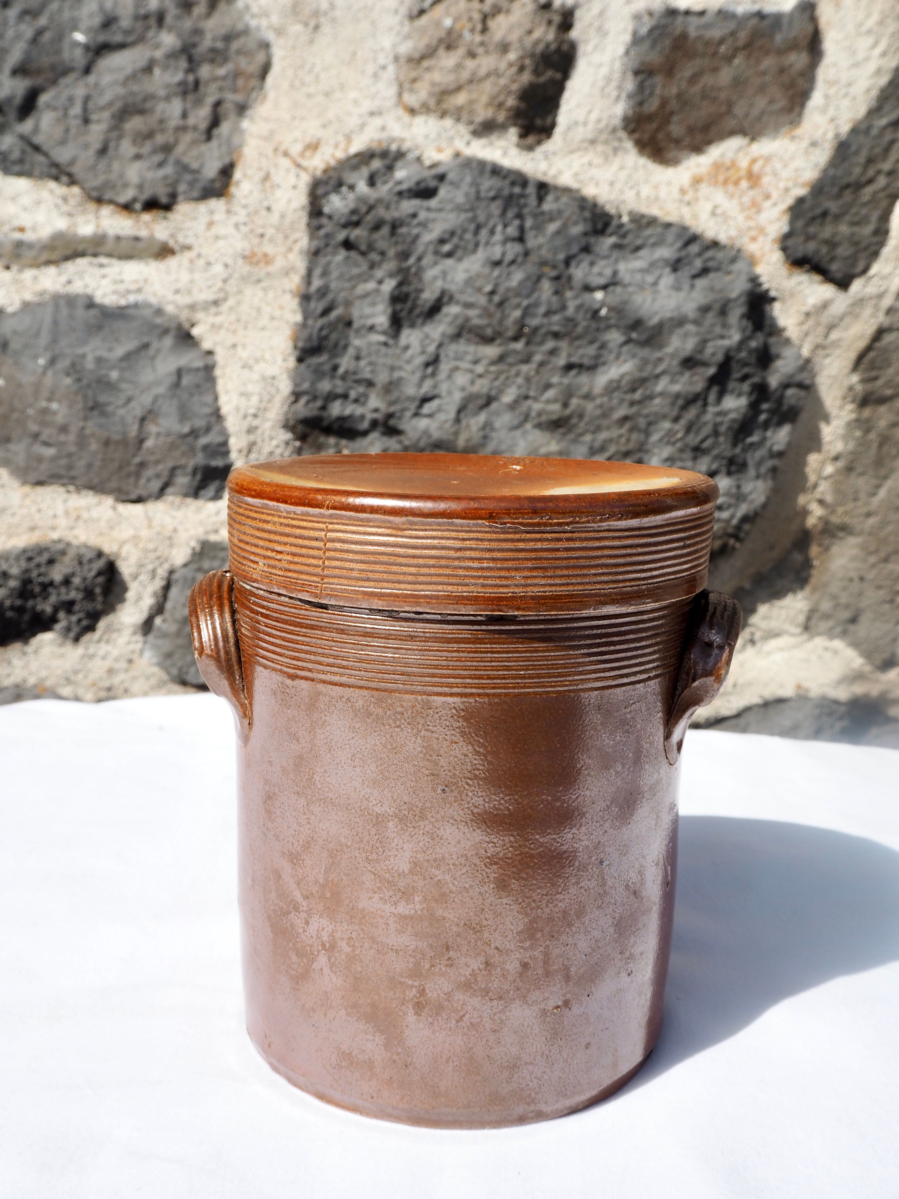 Trio of stoneware pots with lids