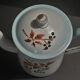 Enamelled sheet metal pourer decorated with black berries early twentieth century