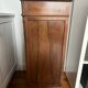 Solid wood storage furniture with a marble top.