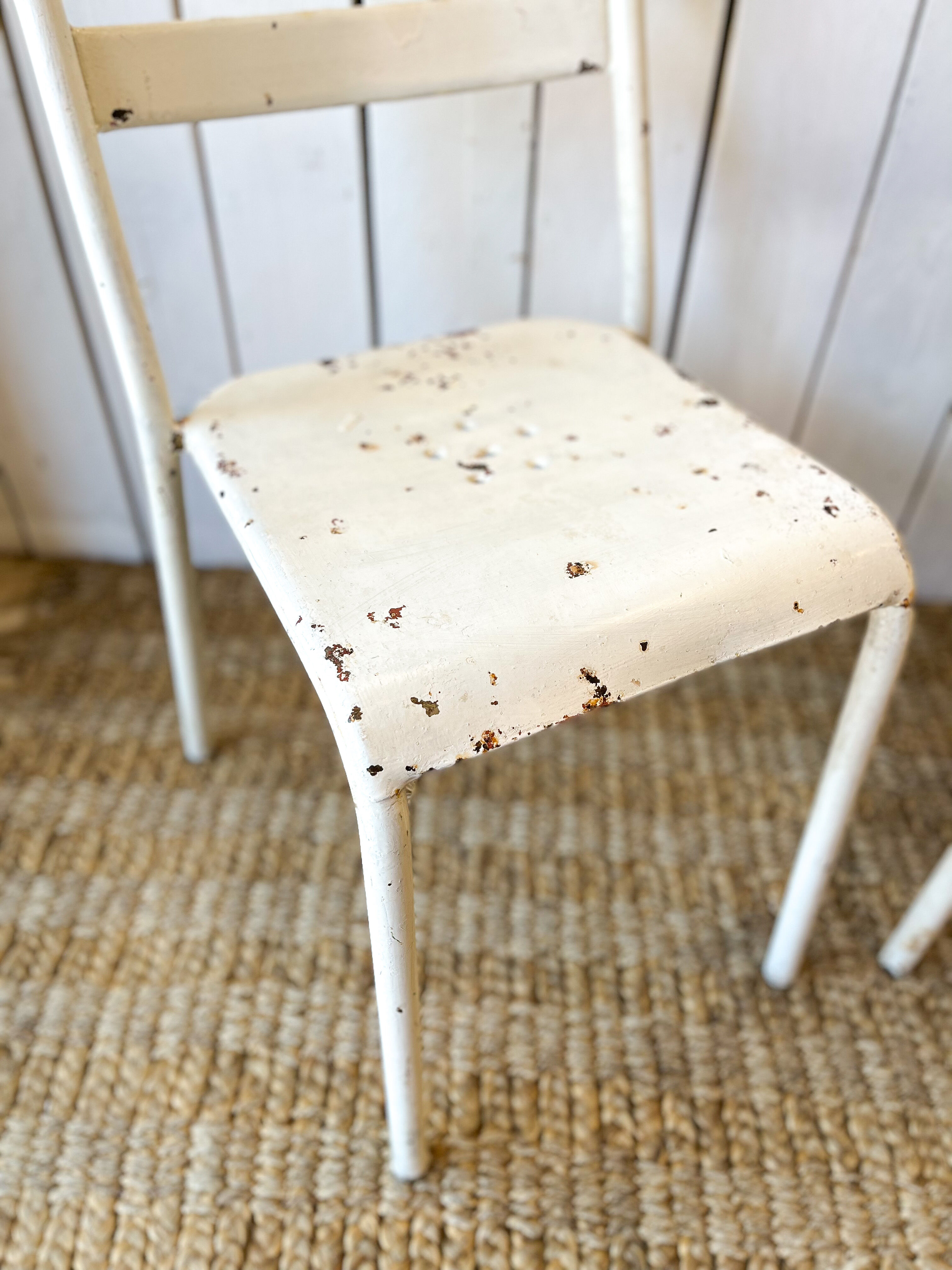 Pair of white metal bistro chairs