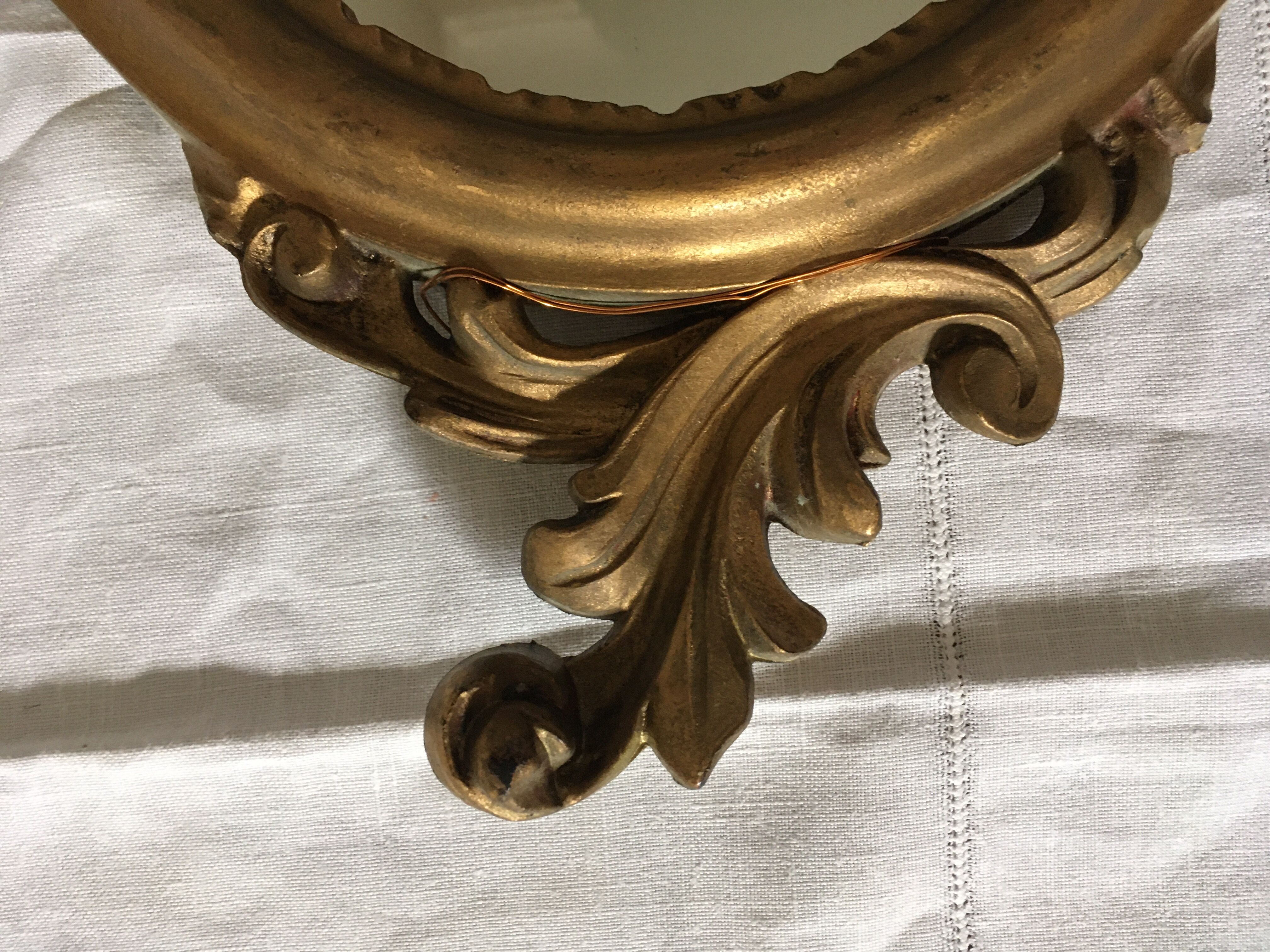 Golden oval mirror